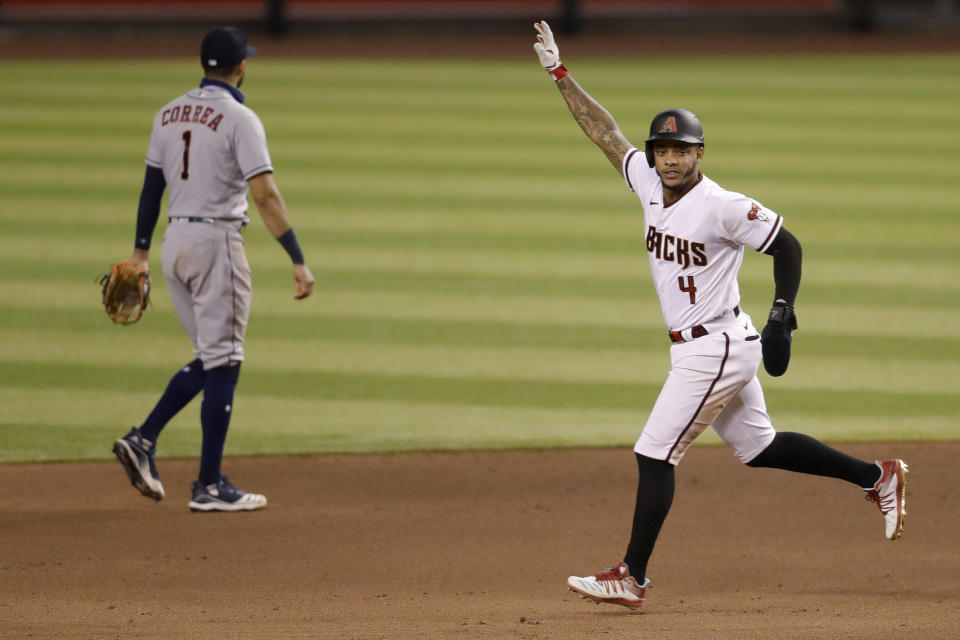 Arizona Diamondbacks' Ketel Mate (4) celebrates after Kole Calhoun hit a two-RBI walk off single as Houston Astros Carlos Correa (1) walks to the dugout after a baseball game Thursday, Aug. 6, 2020, in Phoenix. The Diamondbacks won 5-4. (AP Photo/Matt York)