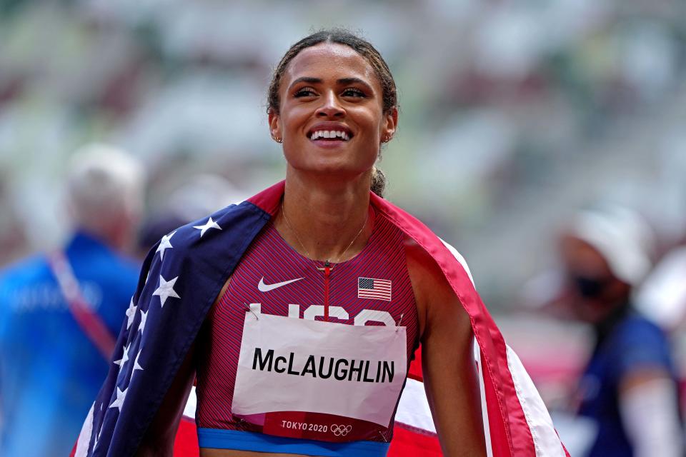 Sydney McLaughlin (USA) celebrates winning the gold medal in the women's 400m hurdles final in a world record time during the Tokyo 2020 Olympic Summer Games at Olympic Stadium.