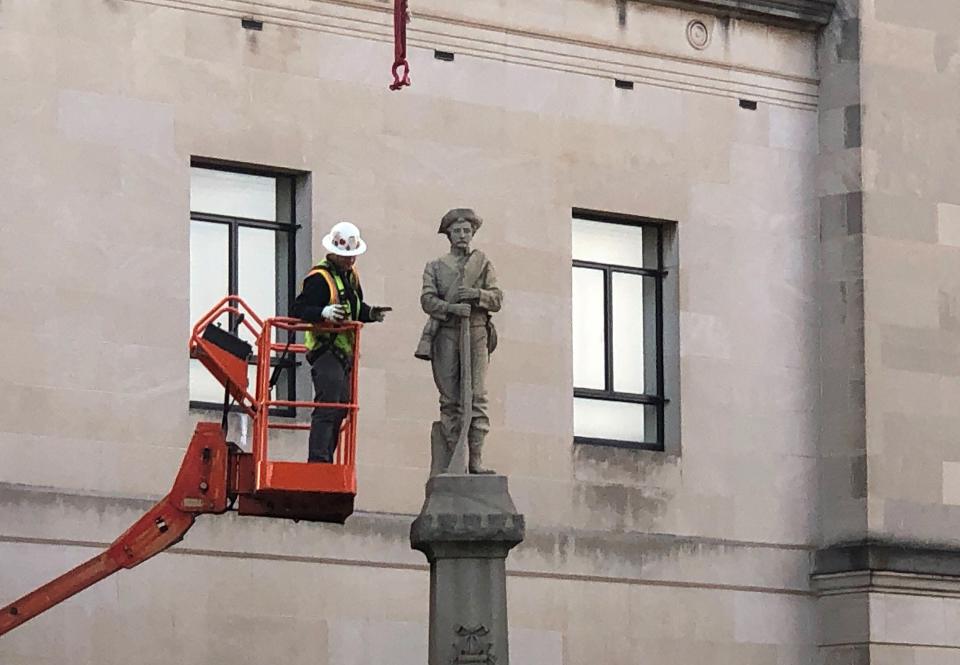 FILE - A workman prepares a Confederate statue for removal on Tuesday, March 12, 2019, in Winston-Salem, N.C. On Friday, Dec. 16, 2022, North Carolina's Supreme Court ruled that the local chapter of United Daughters of the Confederacy lacks standing to challenge the city of Winston-Salem's removal of the Confederate monument on private property, but it can refile a future lawsuit making similar arguments. (AP Photo/Tom Foreman Jr., File)