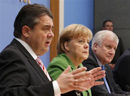 Party leaders German Chancellor Angela Merkel (C) of the Christian Democratic Union (CDU), Horst Seehofer (R) of the Christian Social Union (CSU) and Sigmar Gabriel of the Social Democratic Party (SPD) address a news conference after signing a preliminary agreement, which has still to be approved by the members of the SPD, in the Bundespressekonferenz in Berlin, November 27, 2013. REUTERS/Fabrizio Bensch