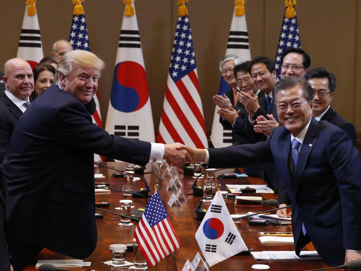 Trump and South Korean President Moon Jae-in shake hands before their summit meeting in Seoul: EPA