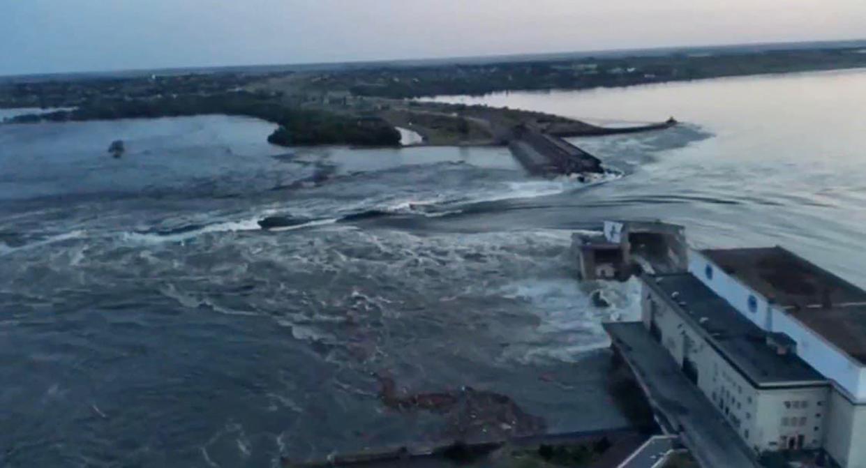 Water rushing through the burst dam (AFP via Getty Images)