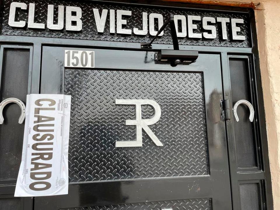 A government "closure" notice is seen on the front door of Club Viejo Oeste, where three individuals were gunned down inside the bar and others were injured on Sunday night in Juárez.