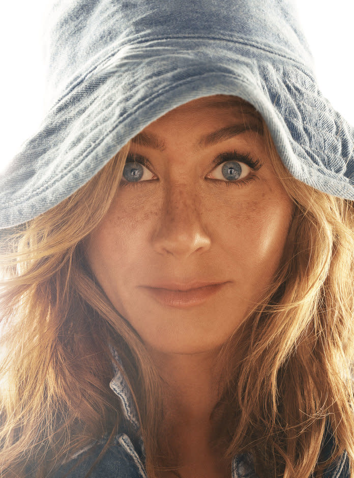 <p>Aniston in a B Sides jacket, a&nbsp;Levi’s shirt, and a Hat Attack hat. Photographed by Michael Thompson.</p>