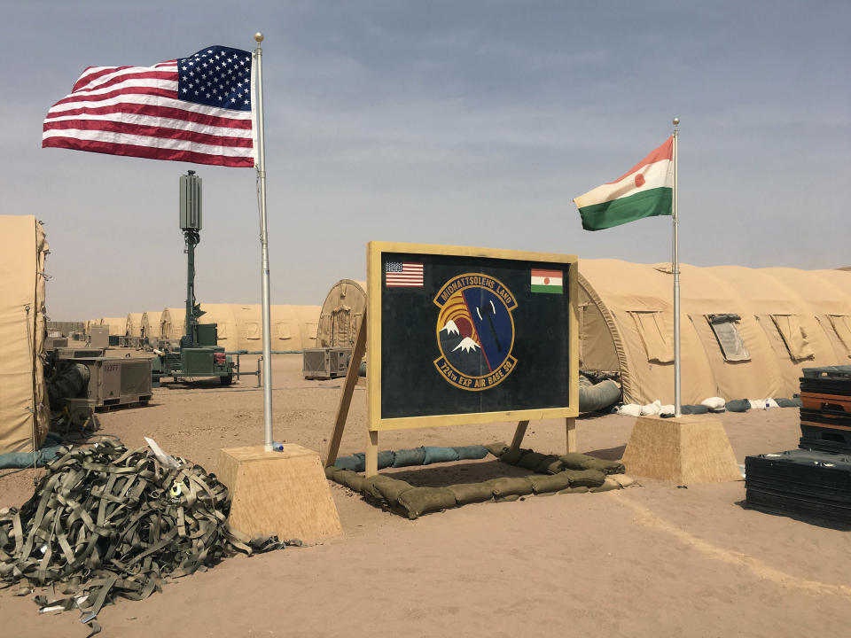 FILE - In this photo taken Monday, April 16, 2018, a U.S. and Niger flag are raised side by side at the base camp for air forces and other personnel supporting the construction of Niger Air Base 201 in Agadez, Niger. The U.S. says it has about 5,200 Africa Command personnel, troops and others, on the continent, plus about 800 other Department of Defense personnel. (AP Photo/Carley Petesch, File)