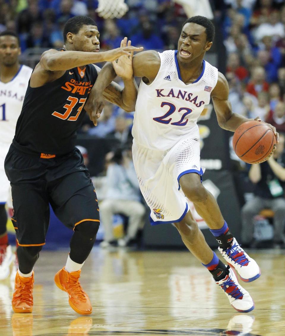 Kansas guard Andrew Wiggins (22) is covered by Oklahoma State guard Marcus Smart (33) during the second half of an NCAA college basketball game in the quarterfinals of the Big 12 Conference men's tournament in Kansas City, Mo., Thursday, March 13, 2014. Kansas defeated Oklahoma State 77-70 in overtime. (AP Photo/Orlin Wagner)