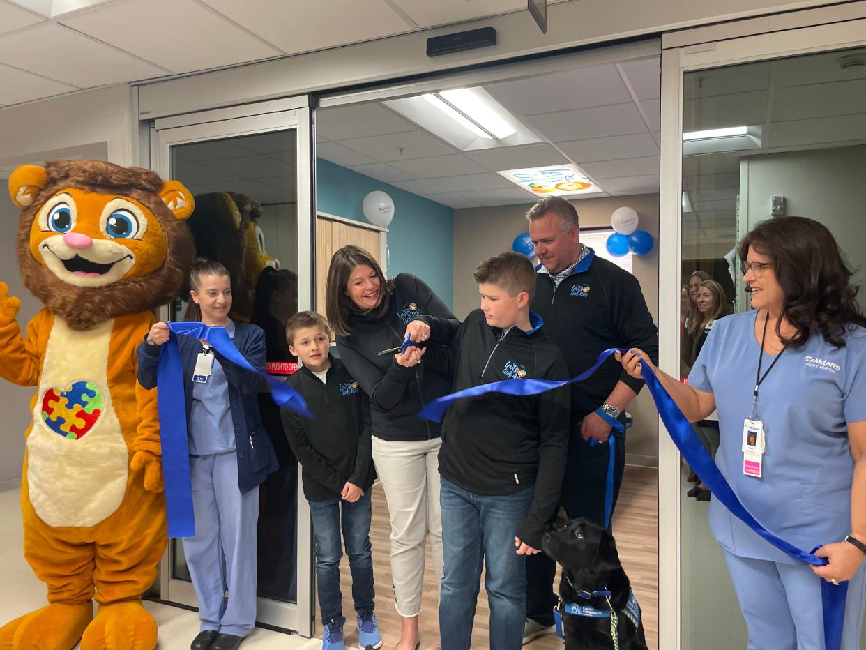 The Wilson Family and McLaren Port Huron staff cutting the ribbon for the new Levi's Link Preop Sensory Bay on May 7, 2024. The new preoperative room was designed to have a calming atmosphere for patients with special needs.