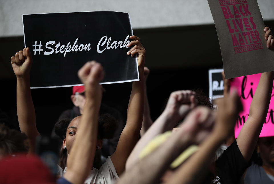 Black Lives Matter activists raise their fists for Stephon Clark.