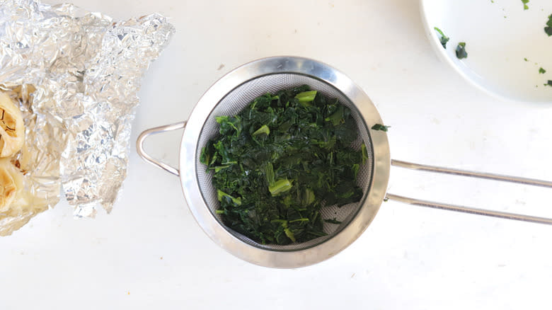 frozen chopped spinach in a strainer