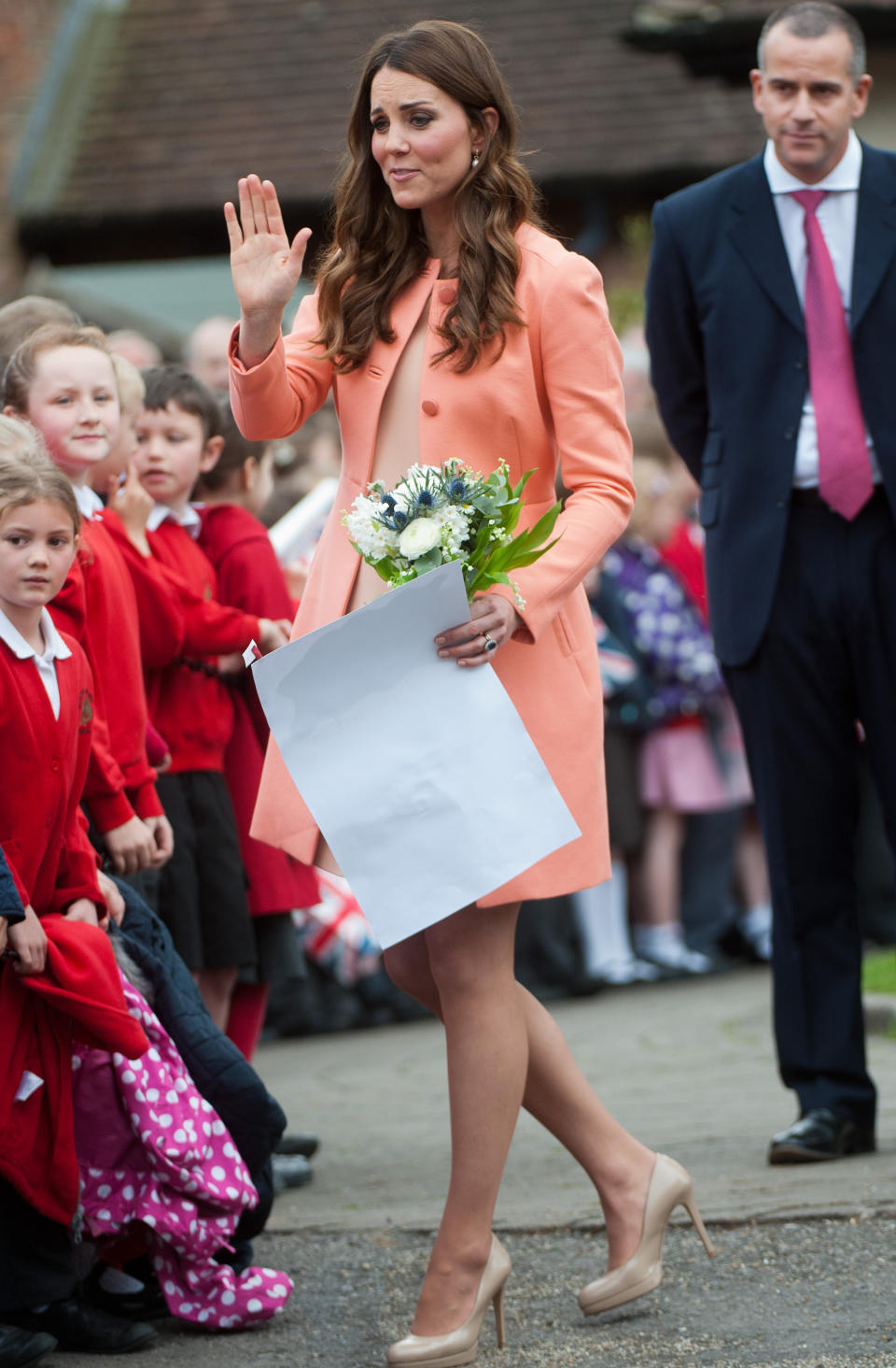 <p>The Duchess covered her stomach in a peach-coloured Tara Jarmon coat while pregnant with Prince George.<br><i>[Photo: PA]</i> </p>