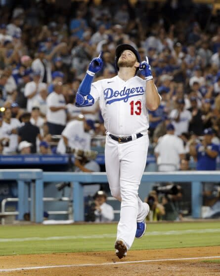 Los Angeles Dodgers third baseman Max Muncy celebrates while crossing home after a solo home run