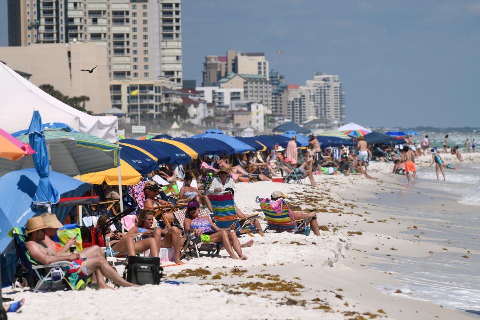 Beachgoers fill the shoreline Monday in Walton County. So far, the county's tourist season has been safer than last year, with fewer public assist calls and no swimming fatalities.