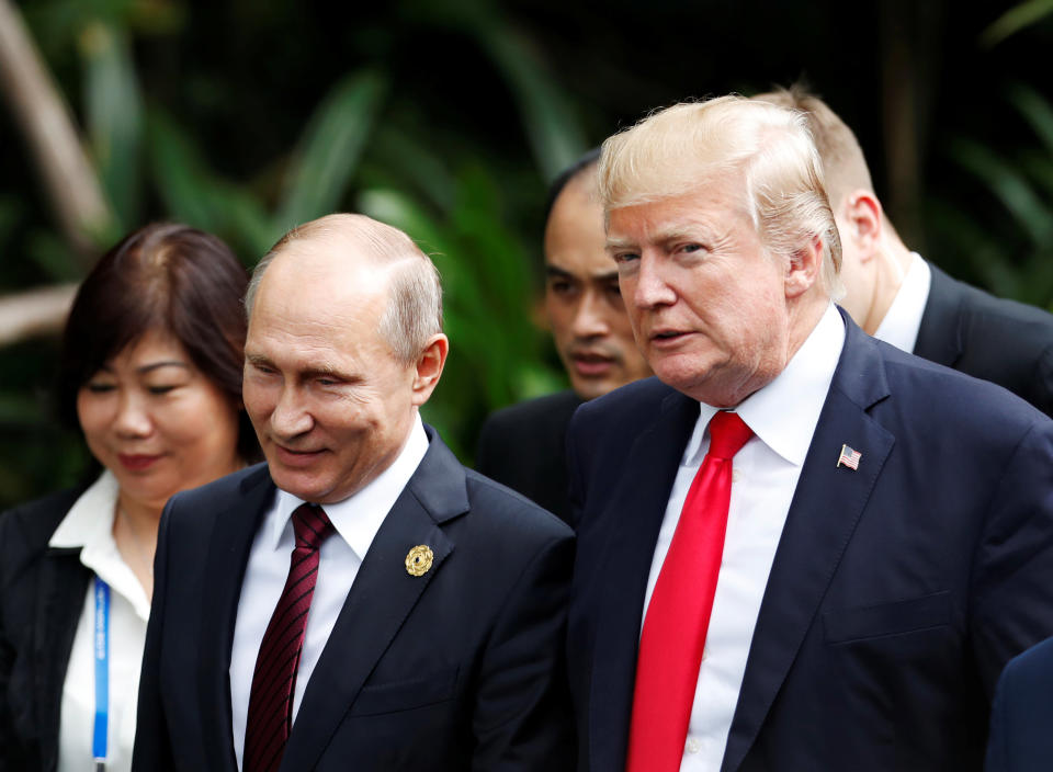 President Donald Trump and Russia's President Vladimir Putin attend a photo session at a summit in Vietnam on Saturday. (Photo: Jorge Silva / Reuters)