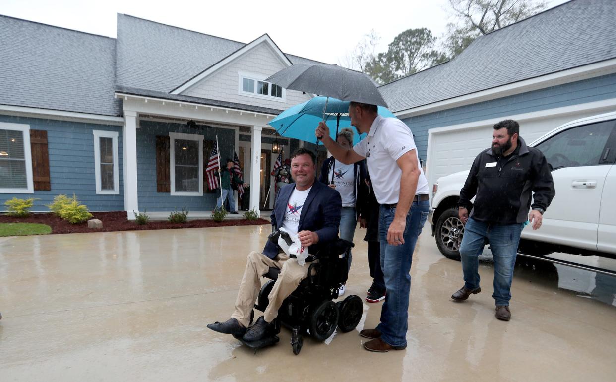 Retired U.S. Army Sgt.1st Class Ryan Davis and his family arrive at their newly built Richmond Hill home on Thursday, October 12, 2023. The Gary Sinise Foundation presented the home to the Davis family during a special ceremony.