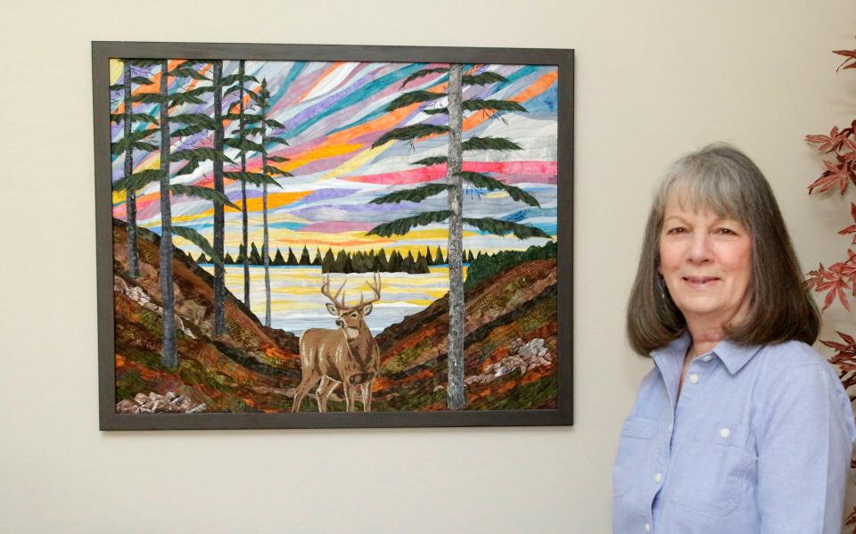 Barbara Strobel Dellger stands by one of her fiber works. Her quilts and other pieces combined her love of the outdoors and art.