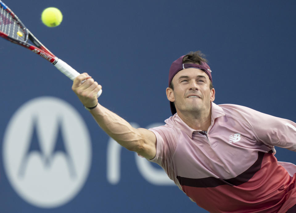 Tommy Paul, of the United States, lunges for a return to Carlos Alcaraz, of Spain, during the National Bank Open men’s tennis tournament Friday, Aug. 11, 2023, in Toronto. (Frank Gunn/The Canadian Press via AP)