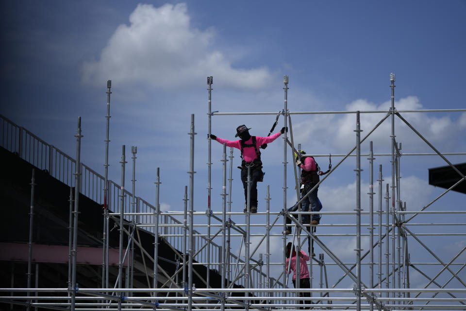 Workers construct additional seating at the previously 18,000-seat DRV Pink stadium, home of Inter Miami MLS soccer team, Wednesday, July 12, 2023, in Fort Lauderdale, Fla. International soccer superstar Lionel Messi is expected to make his debut with the team in a match on July 21, after an introductory event on July 16. (AP Photo/Rebecca Blackwell)