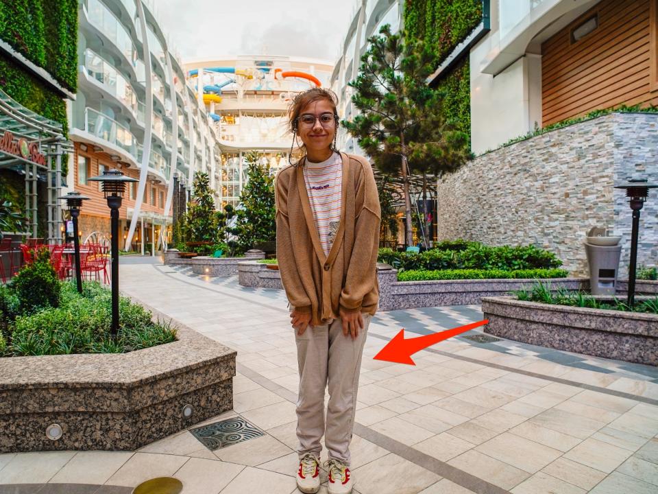 The author on an outdoor deck on the ship, an arrow points to her pants