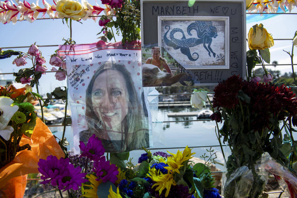 Photographs of loved ones lost in the fire on the scuba boat Conception are placed at a memorial on the Santa Barbara Harbor on Wednesday, Sept. 4, 2019, in Santa Barbara, Calif. A fire raged through the boat carrying recreational scuba divers anchored near an island off the Southern California Coast on Monday, leaving multiple people dead. (AP Photo/Christian Monterrosa )