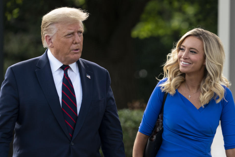 President Donald Trump, accompanied by White House press secretary Kayleigh McEnany, walks to speak with reporters before boarding Marine One on the South Lawn of the White House, Tuesday, Sept. 15, 2020, in Washington. Trump is en route to Philadelphia. (AP Photo/Alex Brandon)