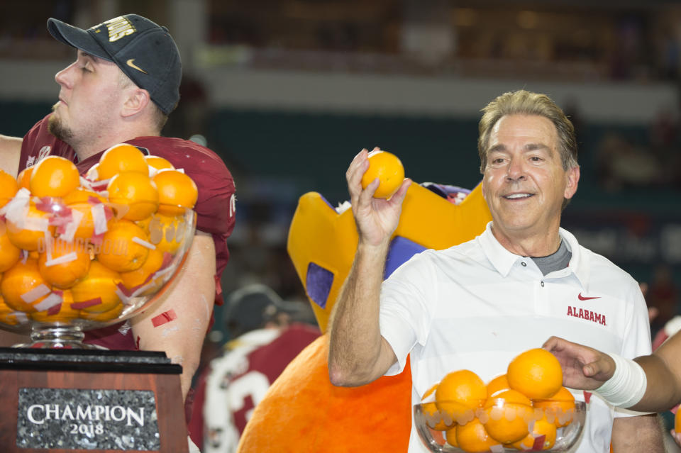 Alabama coach Nick Saban throws oranges to the crowd after the Crimson Tide beat Oklahoma in the CFP semifinal. (Getty)