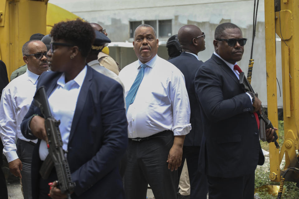 Armed security officers escort Haitian Prime Minister Garry Conille as he visits the General Hospital in Port-au-Prince, Haiti, Tuesday, July 9, 2024. Haiti's prime minister and police chief visited the capital's largest hospital after authorities announced that police took control of the medical institution over the weekend from armed gangs. (AP Photo/Odelyn Joseph)