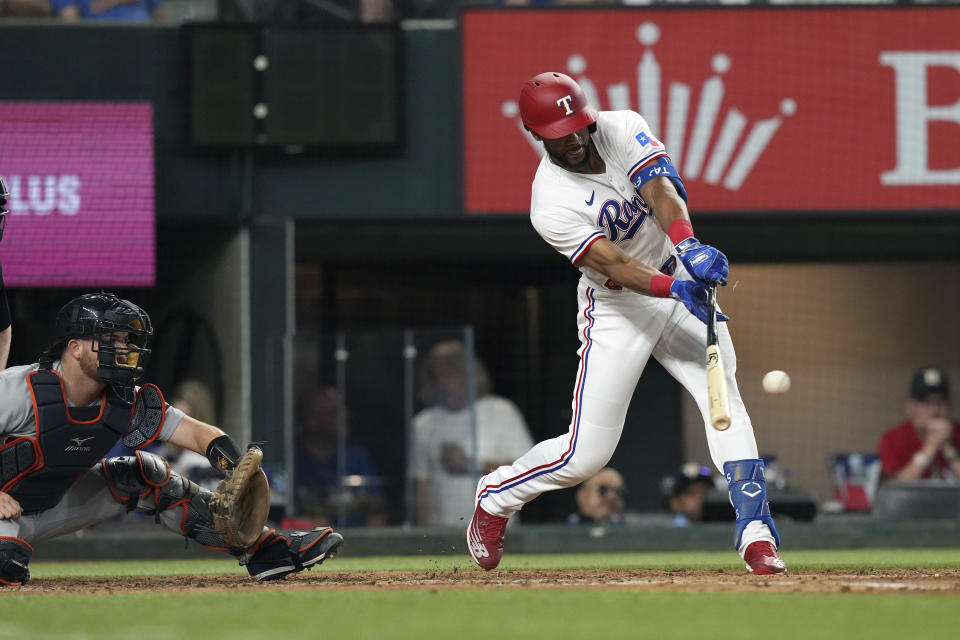 Texas Rangers Leody Taveras hits a single in front of Detroit Tigers catcher Jake Rogers (34) during the sixth inning of a baseball game in Arlington, Texas, Tuesday, June 27, 2023. Rangers Josh Jung scored on the play.(AP Photo/LM Otero)