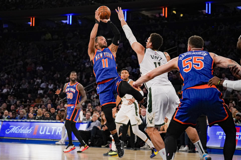 New York Knicks guard Jalen Brunson (11) shoots over Milwaukee Bucks center Brook Lopez (11) during the first half of an NBA basketball game in New York, Saturday, Dec. 23, 2023. (AP Photo/Peter K. Afriyie)