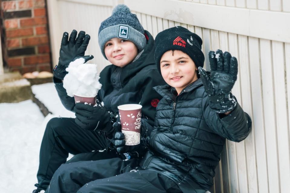 Staten Island mom Veronica Gill Mannarino, 55, also let her children enjoy the snow day in lieu of logging on to their computers remotely. Her 12-year-old Ryan (left) and 10-year-old Tommy enjoyed hot chocolate and time outside Tuesday at home in Staten Island. Stefano Giovannini