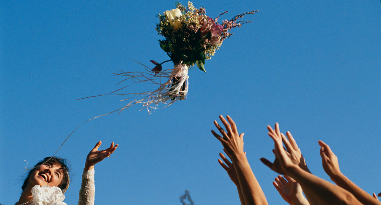 Brides throw their bouquets at weddings