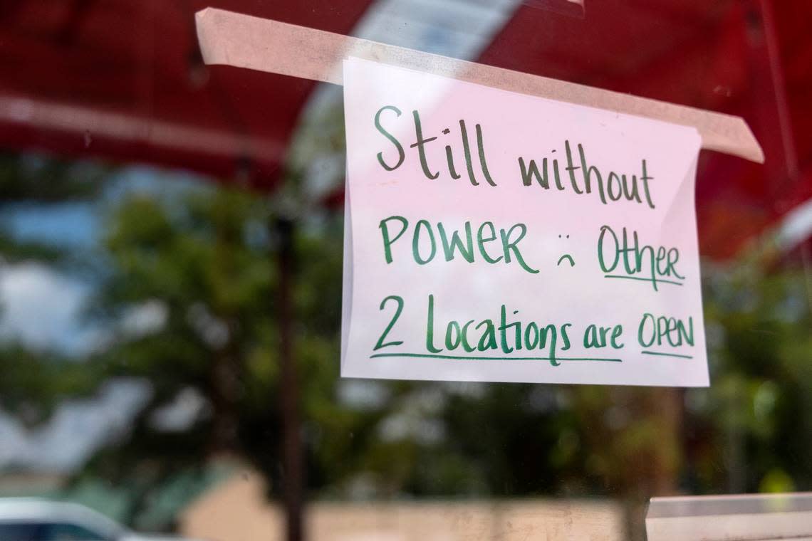 A sign posted on the door of Cocoa Cinnamon on Chapel Hill Road states that the business remains without power on Thursday, Aug. 17, 2023, following Tuesday’s severe storms in Durham, N.C.