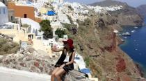 A tourist takes a selfie in the village of Oia on the Greek island of Santorini, Greece, July 1, 2015. REUTERS/Cathal McNaughton/Files