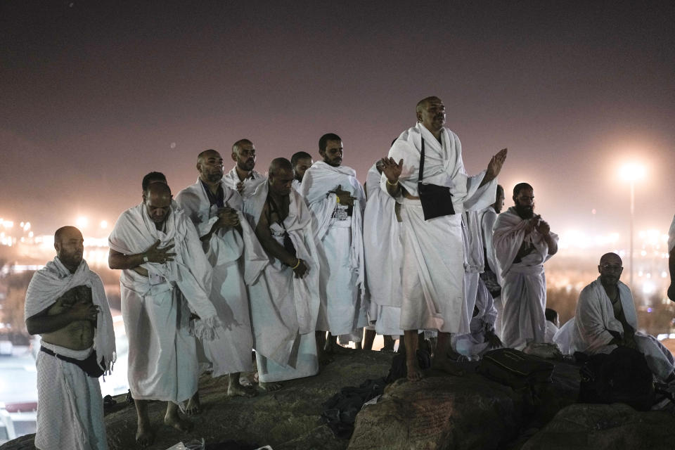 Muslim pilgrims pray on the rocky hill known as the Mountain of Mercy, on the Plain of Arafat, during the annual Hajj pilgrimage, near the holy city of Mecca, Saudi Arabia, Tuesday, June 27, 2023. Muslim pilgrims in Mecca circled the Kaaba, Islam's holiest site, and then converged on a vast tent camp in the nearby desert, officially opening the annual Hajj pilgrimage on Monday, returning to its full capacity for the first time since the coronavirus pandemic. (AP Photo/Amr Nabil)