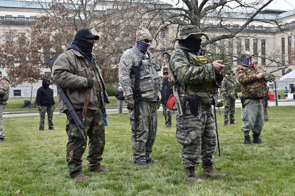 A group of armed protesters listen to speakers during a rally on the lawn of the Kentucky State Capitol in Frankfort. (Photo: ASSOCIATED PRESS)