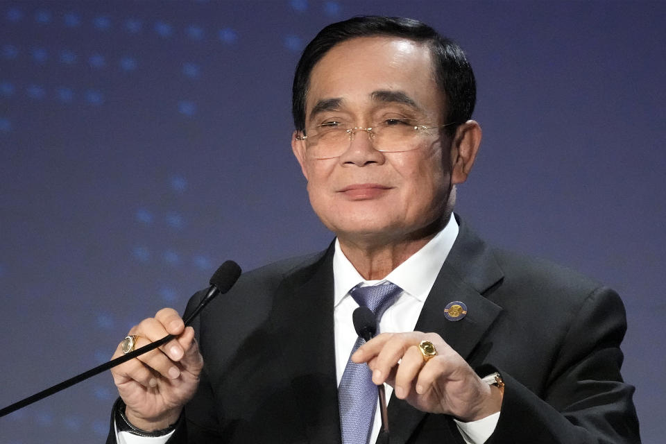 FILE - Thailand's Prime Minister Prayuth Chan-ocha adjusts microphones to deliver a speech at a session of the International Conference on "The Future of Asia" in Tokyo on May 26, 2022. Prayuth is expected to win his fourth and final no-confidence vote in Parliament on Saturday, July 23, 2022, ahead of a general election next year. (AP Photo/Eugene Hoshiko, File)