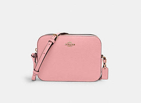 Product photo of rectangular Mini Camera Bag in light pink. Image via Coach Outlet.