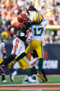 Green Bay Packers wide receiver Davante Adams (17) makes a catch over Cincinnati Bengals cornerback Chidobe Awuzie (22) in the second half of an NFL football game in Cincinnati, Sunday, Oct. 10, 2021. (AP Photo/Bryan Woolston)