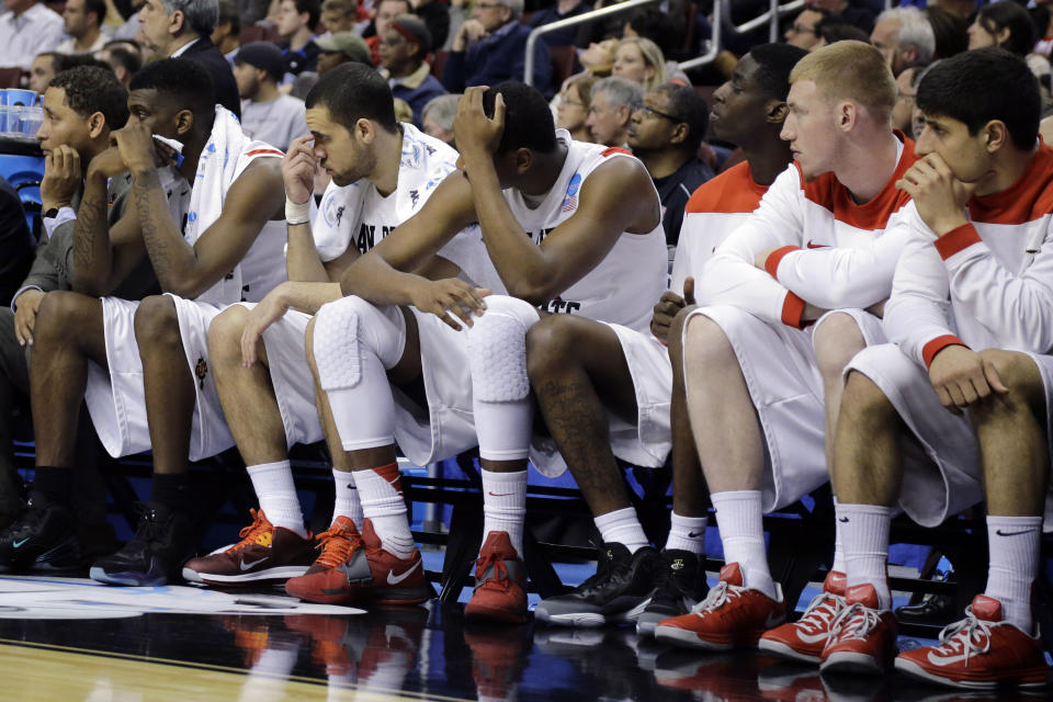 FILE - In this March 24, 2013, file photo, San Diego State players watch from the bench in the final minutes of a third-round game against Florida Gulf Coast in the NCAA college basketball tournament in Philadelphia. Florida Gulf Coast won 81-71. The high-flying FGSU Eagles and their showstopping offense earned their place in NCAA Tournament lore when, as a No. 15 seed in the South Region, they upset Georgetown and San Diego State in Philadelphia to reach the 2013 Sweet 16. (AP Photo/Matt Slocum, File)