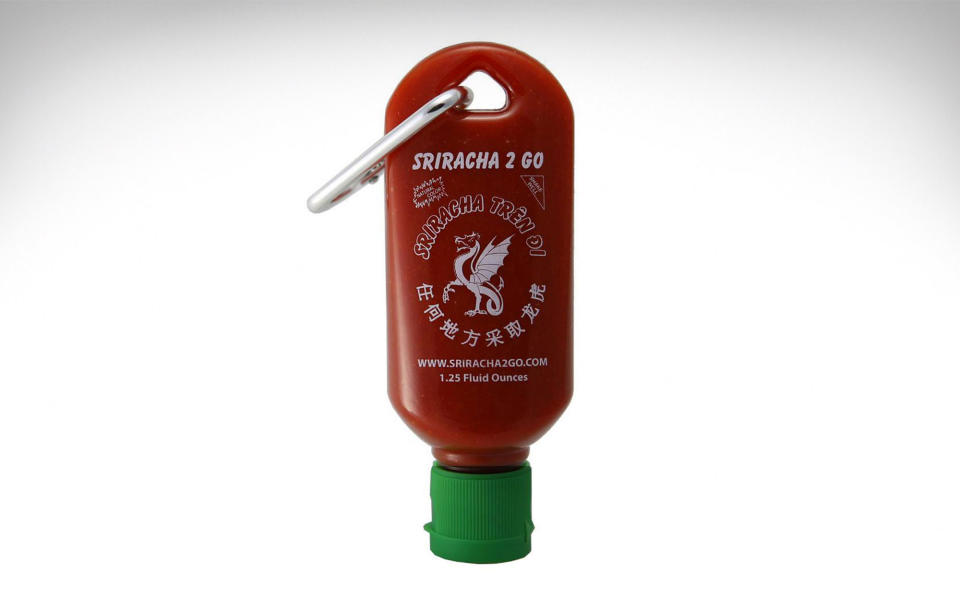 <p>Add a little spice to your travels with a TSA-friendly size of everyone’s favorite Asian chili condiment.</p> <p>To buy: <a rel="nofollow noopener" href="https://www.amazon.com/Sriracha-Keychain-Combo-Ounce-Included/dp/B00X0233OU//ref=as_li_ss_tl?ie=UTF8&linkCode=ll1&tag=travandleis07-20&linkId=c47e6100c02a19c35964ad4903f44be0" target="_blank" data-ylk="slk:amazon.com;elm:context_link;itc:0;sec:content-canvas" class="link ">amazon.com</a>, $12</p>