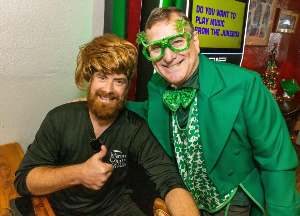 George Carrasco, owner of Molly Maguire's of Ocala, right, poses with customer Matt Young, left, during lunch on March 2. The restaurant was a favorite place to visit on St. Patrick's Day.