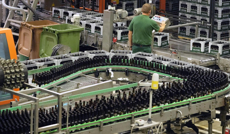 FILE -- A worker controls the bottling at the Veltins beer brewery in Meschede, Germany, Wednesday, Aug. 24, 2022. The Federal Statistical Office said on Wednesday that German-based breweries and distributors sold about 8.8 billion liters (2.3 billion gallons) of beer last year, a 2.7% increase compared with 2021. (AP Photo/Martin Meissner,file)