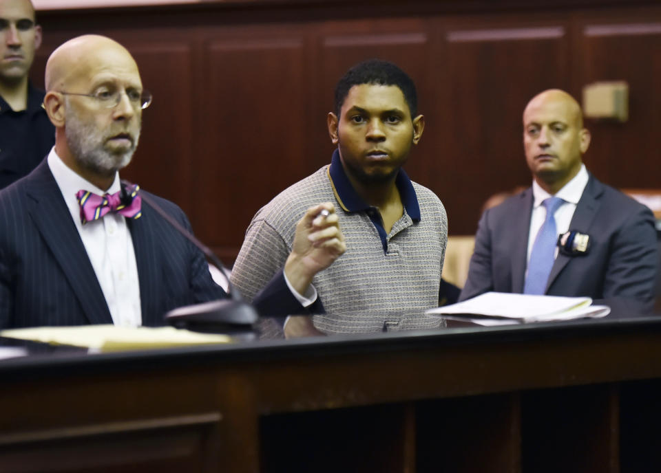 Randy Santos, center, is arraigned in criminal court for the murder of four homeless men, Sunday, Oct. 6, 2019, in New York. He was ordered held without bail. (Rashid Umar Abbasi/New York Post via AP, Pool)