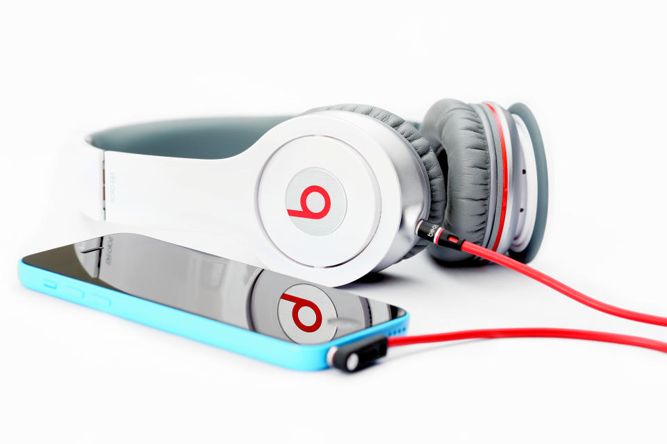Placentia, CA, USA - June 2, 2014: Beats by Dr. Dre connected to an Apple iPhone 5C on white background, close up.  