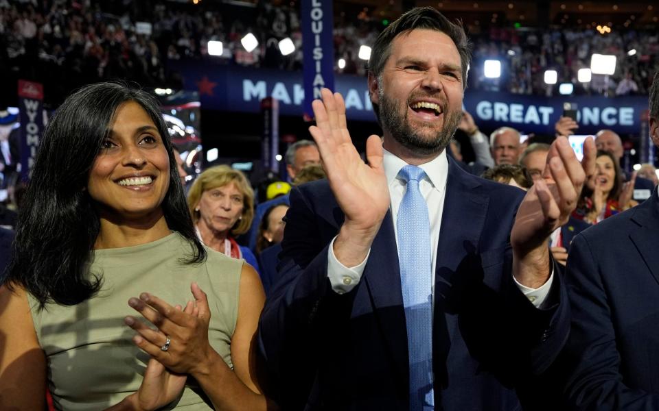 Republican vice presidential candidate Sen. JD Vance, R-Ohio, and his wife Usha Chilukuri Vance arrive on the floor during the first day of the 2024 Republican National Convention