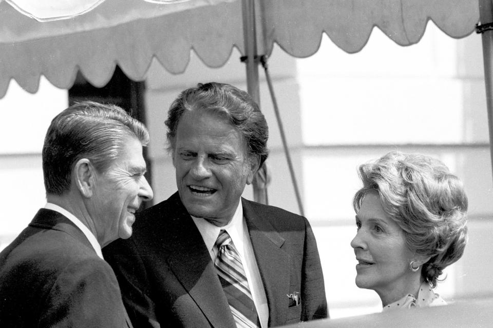 <p>The Rev. Billy Graham, center, talks with President Ronald Reagan and first lady Nancy Reagan at the White House on July 18, 1981. (Photo: J. Scott Applewhite/AP) </p>