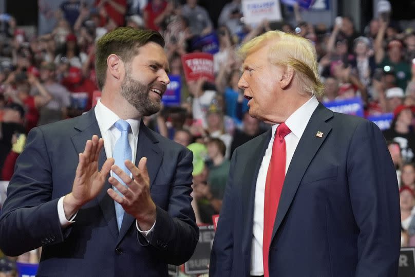 Republican presidential candidate former President Donald Trump and Republican vice presidential candidate Senator JD Vance chat at the Michigan event