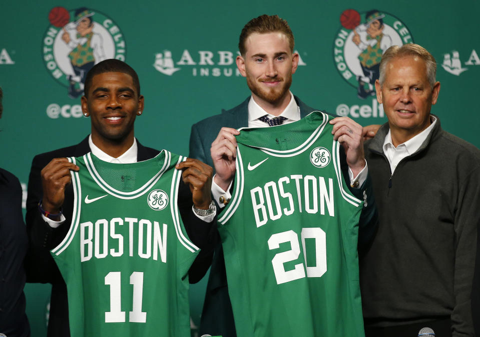 Kyrie Irving and Gordon Hayward hold up their new jerseys with Celtics team president Danny Ainge on Friday. (AP Photo/Winslow Townson)