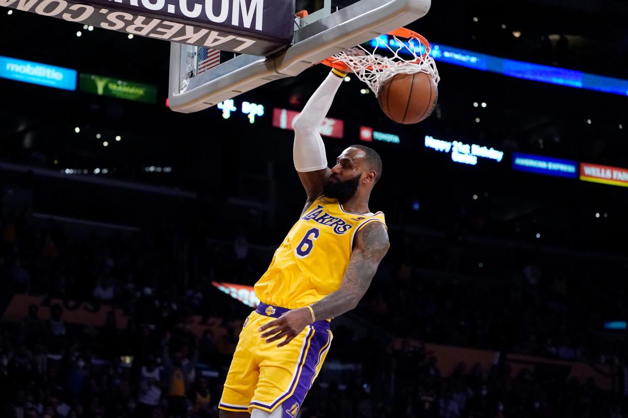 Los Angeles Lakers forward LeBron James dunks during the second half of the team's NBA basketball game against the Boston Celtics on Tuesday, Dec. 7, 2021, in Los Angeles. (AP Photo/Marcio Jose Sanchez)