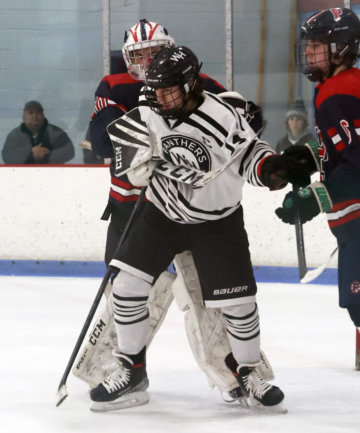 Pembroke goalie Kyle Ready is called for a slashing penalty on Whitman-Hanson's Alex Ethier during their game at the Rockland Ice Arena on Saturday, Jan. 14, 2023.