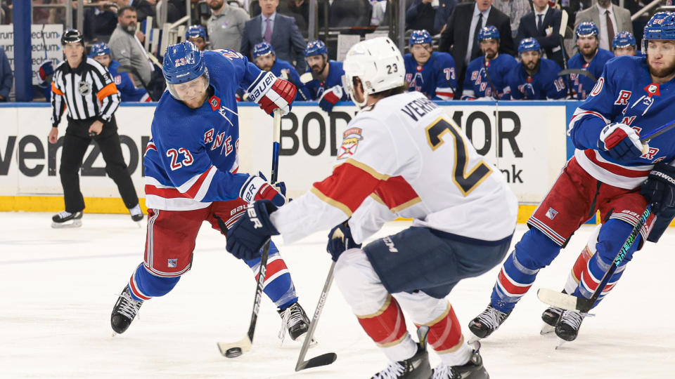 New York Rangers defenseman Adam Fox (23) shoots the puck while Florida Panthers center Carter Verhaeghe (23) defends during the second period of the second game of the Eastern Conference Final of the 2024 Stanley Cup Playoffs at Madison Square Garden. 